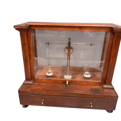 Sale Photo Thumbnail #14: Antique brass analytical scale housed inside a glazed mahogany display case with a lower drawer.
