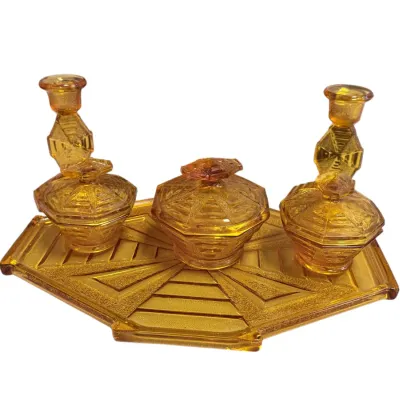 Sale Photo Thumbnail #61: Vintage Art Deco amber depression glass vanity set including a tray, three lidded jars, and two candle holders.