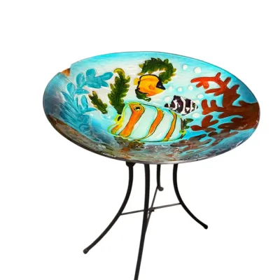 Sale Photo Thumbnail #44: Hand-painted glass birdbath featuring a colorful tropical fish and coral reef motif on a black metal folding stand.