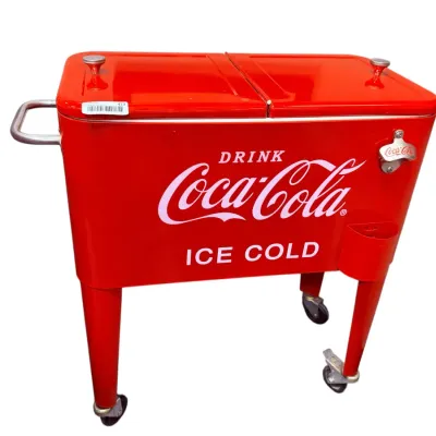 Sale Photo Thumbnail #35: Vintage-style red Coca-Cola rolling ice chest cooler featuring dual-hinged lids, built-in bottle opener, and caster wheels.