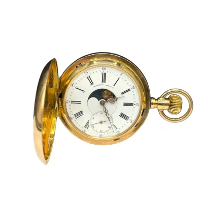 Sale Photo Thumbnail #77: Antique gold-toned hunter case pocket watch with moon phase indicator, Roman numeral dial, and small seconds subdial.