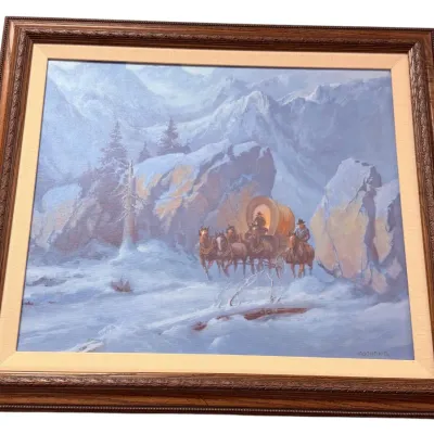 Sale Photo Thumbnail #27: Framed Western landscape painting depicting a horse-drawn covered wagon traversing a snowy mountain pass, signed Cochrane lower right.