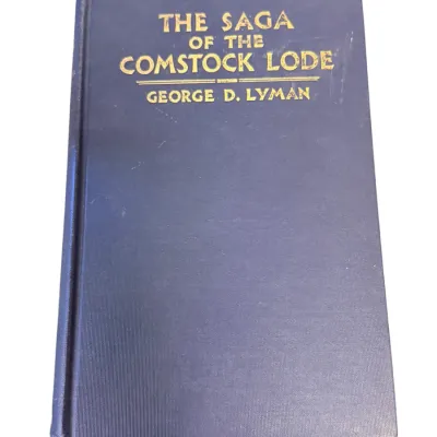 Sale Photo Thumbnail #59: Hardcover copy of 'The Saga of the Comstock Lode' by George D. Lyman, featuring a blue cloth cover with gilt lettering.