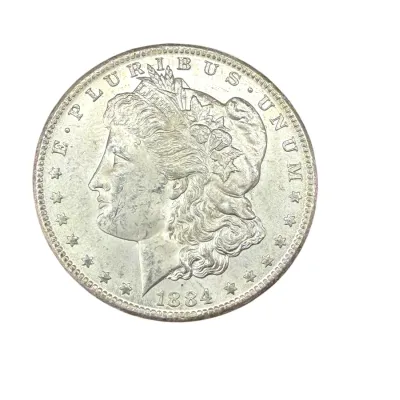 Sale Photo Thumbnail #74: Obverse side of an 1884 Morgan silver dollar showing Lady Liberty in profile.