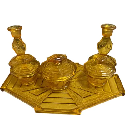 Sale Photo Thumbnail #52: Vintage Art Deco amber depression glass vanity set including a tray, pair of candlestick holders, and three lidded trinket jars.