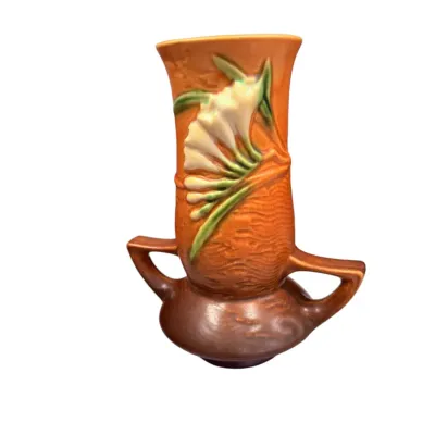 Sale Photo Thumbnail #15: Vintage Roseville Freesia pottery vase featuring dual handles and embossed floral details on an orange-to-brown textured body.