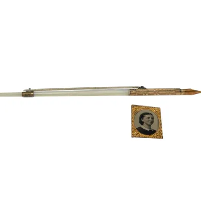 Sale Photo Thumbnail #71: Antique mother-of-pearl and gold-filled dip pen with retractable nib alongside a small ornate brass-framed miniature portrait.