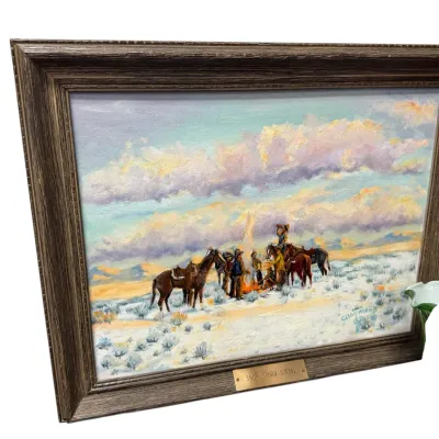 Sale Photo Thumbnail #50: Framed Western oil painting titled 'Snow Storm Social' by C. Hammond, depicting figures and horses gathered around a fire in a snowy landscape.