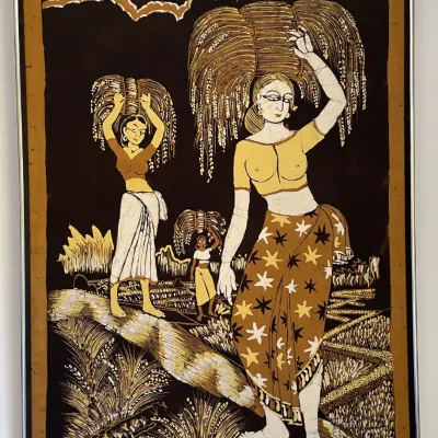 Sale Photo Thumbnail #53: Framed Sri Lankan batik textile art by Eric Suriyasena depicting women harvesting grain, presented in a simple silver-tone metal frame.