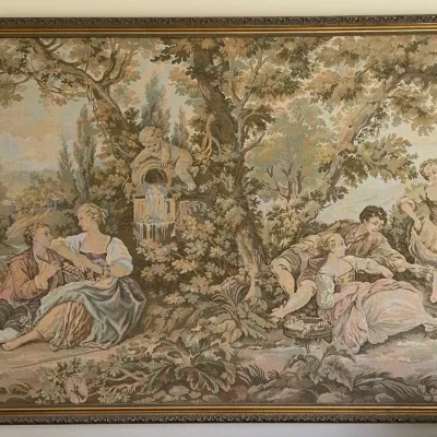 Sale Photo Thumbnail #9: Large framed vintage wall tapestry depicting a pastoral French Rococo style scene with figures and a cherub fountain, housed in a thin gilt frame.