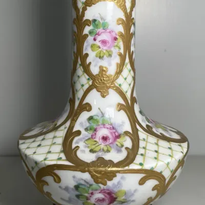 Sale Photo Thumbnail #38: Antique hand-painted opal glass vase with gilded scrollwork, floral cartouches, and a brass-mounted rim and base.