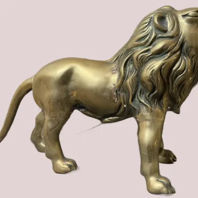 Sale Photo Thumbnail #63: Brass roaring lion figurine depicted standing in a dynamic pose with open jaws.