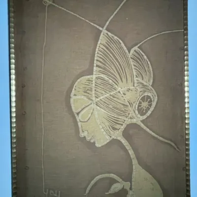 Sale Photo Thumbnail #51: Framed mid-century batik fabric art featuring an abstract figure profile in a metallic segmented frame, signed and dated 1970.