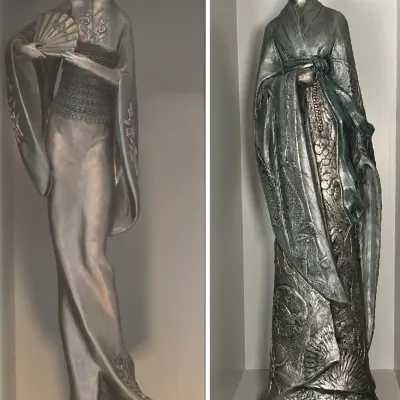 Sale Photo Thumbnail #55: Pair of vintage Asian-style metallic statues, featuring a woman holding a folding fan and a man in traditional floral-embossed robes.