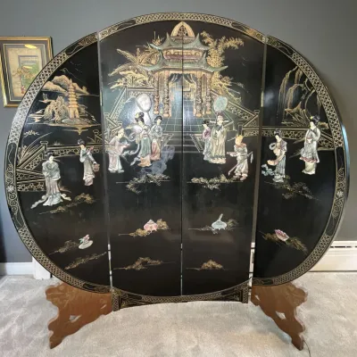 Sale Photo Thumbnail #74: Vintage Asian black lacquer four-panel circular folding screen depicting figures in a landscape with mother-of-pearl or soapstone inlays.