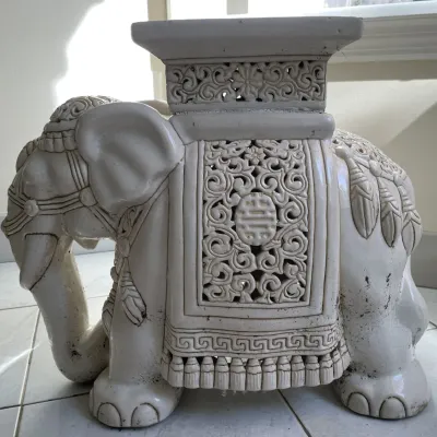 Sale Photo Thumbnail #61: Off-white ceramic Asian-style elephant garden stool with pierced openwork carving and traditional decorative harness details.