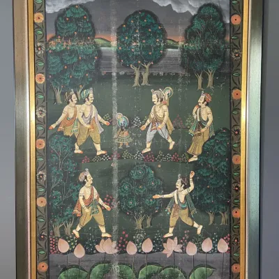 Sale Photo Thumbnail #44: Framed Indian miniature-style artwork depicting figures in a lush landscape with a decorative floral border.