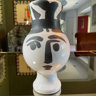 Sale Photo Thumbnail #14: Picasso-style ceramic face vase in black and white glaze, displayed on a mirrored surface.