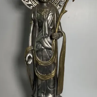 Sale Photo Thumbnail #59: Cast metal standing Buddha statue with a flame halo and lotus pedestal base, featuring mixed silver-tone and brass-tone accents.