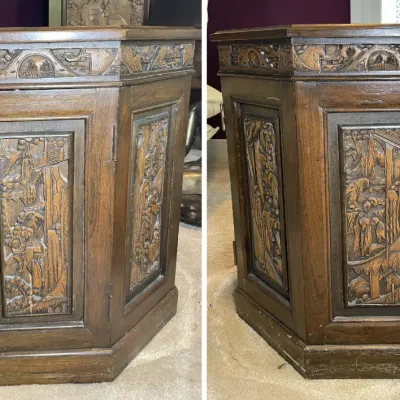 Sale Photo Thumbnail #71: Vintage Asian-style hand-carved octagonal wooden side table or cabinet featuring detailed relief panels depicting natural landscapes and figures.