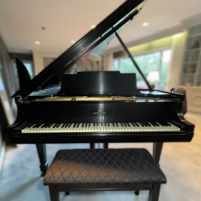 Sale Photo Thumbnail #73: Steinway & Sons black grand piano with matching upholstered bench, shown with lid open.