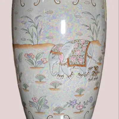 Sale Photo Thumbnail #40: Large Asian-style iridescent ceramic floor vase with elephant motif, featuring beaded blue accents and a carved wooden display stand.