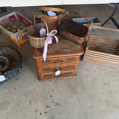 Sale Photo Thumbnail #210: Small vintage three-drawer wooden mini chest, displayed alongside various woven baskets, wooden tote crates, and glassware.