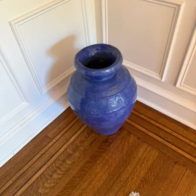 Sale Photo Thumbnail #111: Large Cobalt blue glazed ceramic floor urn with a rustic, hand-coiled finish sitting in a room corner.