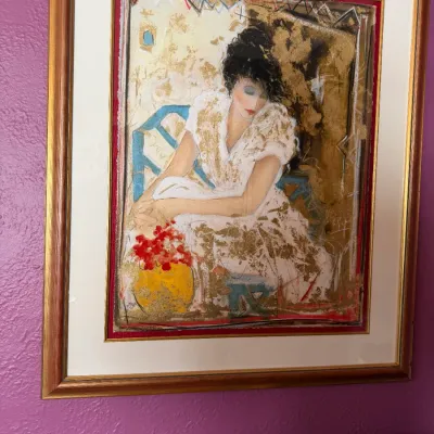 Sale Photo Thumbnail #114: Framed mixed media artwork featuring gold leaf accents and depicting a seated woman in a white dress, housed in a double-matted wood and gold frame.