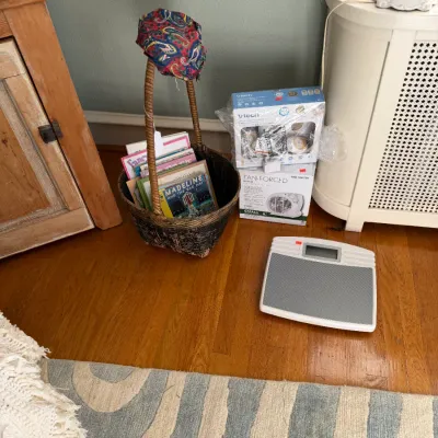 Sale Photo Thumbnail #168: Collection of household items including a tall woven basket filled with children's books, a digital scale, boxed VTech baby monitor, and a boxed fan-forced heater.