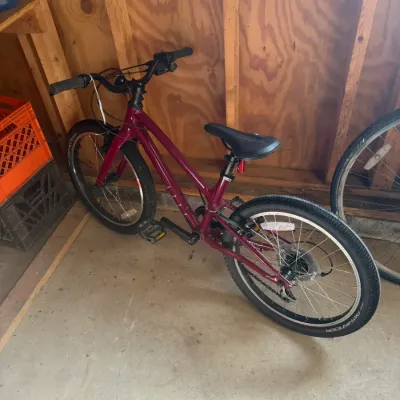 Sale Photo Thumbnail #215: Maroon Specialized youth mountain bike fitted with Pathfinder tires, shown in good used condition.