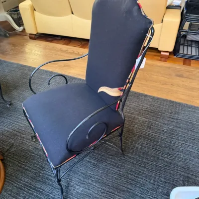 Sale Photo Thumbnail #128: High-back accent armchair with wrought iron frame and dark blue upholstered seat and back.