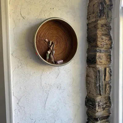Sale Photo Thumbnail #87: Round woven rope wall shelf with a metal frame, featuring a rustic natural fiber interior.
