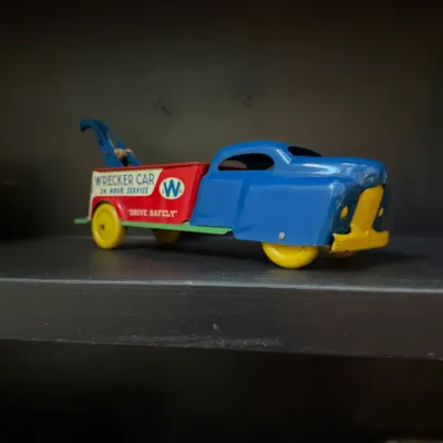 Sale Photo Thumbnail #145: Vintage Wyandotte tin litho 'Wrecker Car' tow truck toy with blue, red, and yellow paint.