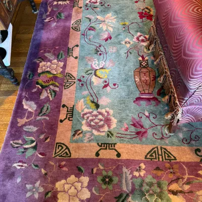 Sale Photo Thumbnail #92: Vintage Chinese Nichols style Peking wool area rug featuring a light teal field with floral motifs, framed by a thick purple border.