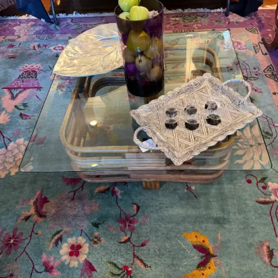 Sale Photo Thumbnail #112: Mid-century modern bentwood and glass square coffee table, displayed with decorative trays and artificial fruit on a floral area rug.