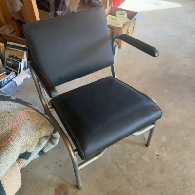 Sale Photo Thumbnail #225: Vintage mid-century office armchair with black vinyl upholstery and tubular metal frame.