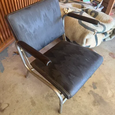 Sale Photo Thumbnail #224: Vintage mid-century industrial armchair with black vinyl upholstery and tubular metal frame.
