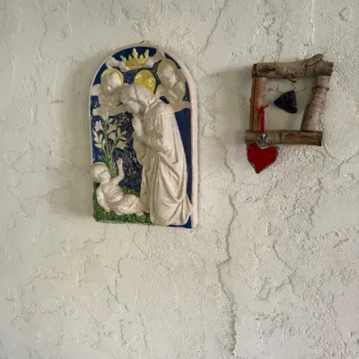 Sale Photo Thumbnail #81: Glazed ceramic religious wall plaque featuring Mary and the Christ Child, paired with a rustic twig picture frame with a hanging heart charm.