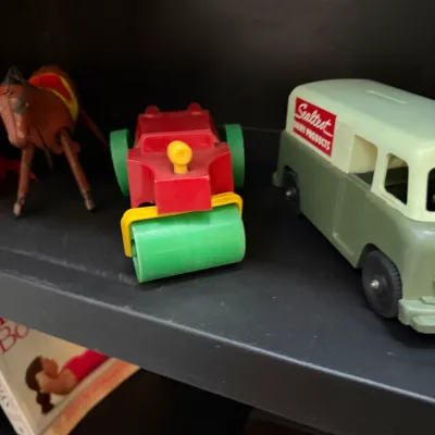 Sale Photo Thumbnail #147: Collection of vintage plastic toys including a Sealtest Dairy Products delivery van bank, a colorful steamroller, and a toy horse.