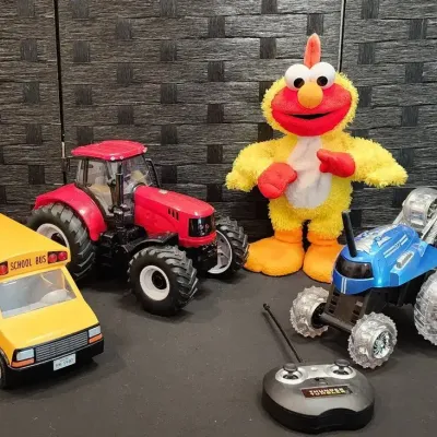 "Chicken Dance" Elmo, Red Light-up Tractor, Remote-controlled Stunt Car & Yellow Bus