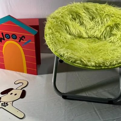 Lime green faux fur dish chair alongside a colorful doghouse-shaped shelf unit and a dog-themed coat hanger.