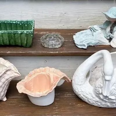 Collection of vintage decorative ceramics and glassware, including a large white swan planter, two seashell planters, a green rectangular...