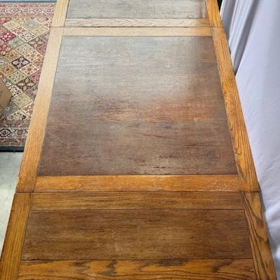 Vintage oak extension dining table featuring parquet-style panel insert tabletop with pull-out leaves at each end.