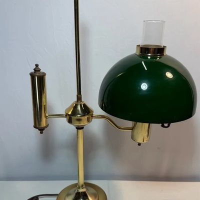 Vintage brass student desk lamp featuring a green cased-glass shade, clear glass chimney, and adjustable height post.