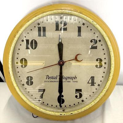 Vintage Postal Telegraph synchronous electric wall clock with a yellow painted frame and glass front face, manufactured by Hammond...