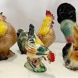 Collection of vintage ceramic rooster-themed kitchenware, including hand-painted figurines, a planter, and a pair of matching mugs.