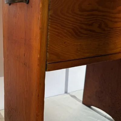 Vintage handmade wooden bench with a side metal handle and warm pine finish.
