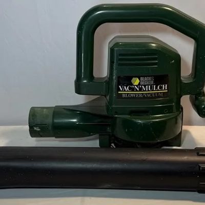 Black & Decker Vac 'N' Mulch electric blower/vacuum with detached nozzle attachment, showing light wear.