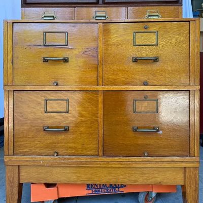 Vintage oak stackable card catalog and file cabinet unit with brass hardware and label holders.